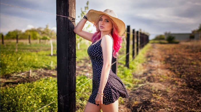 Woman in polka dot dress and straw hat