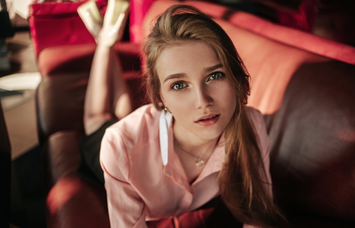 Woman with green eyes lying on a couch