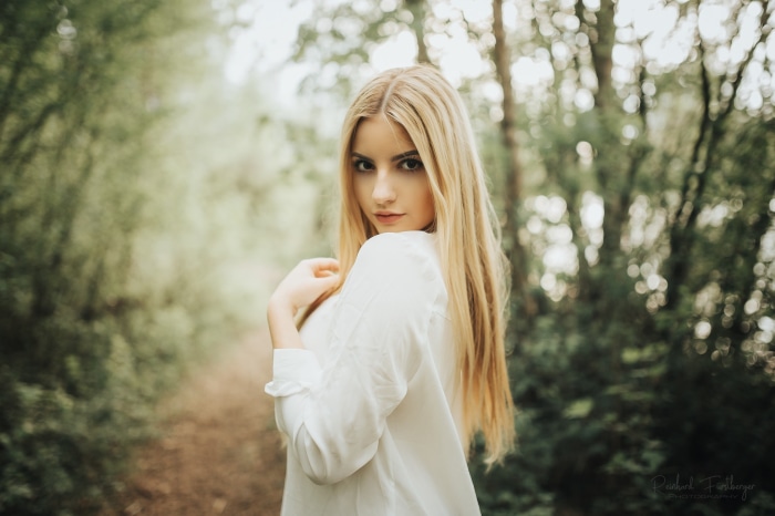 Model in white shirt in forest