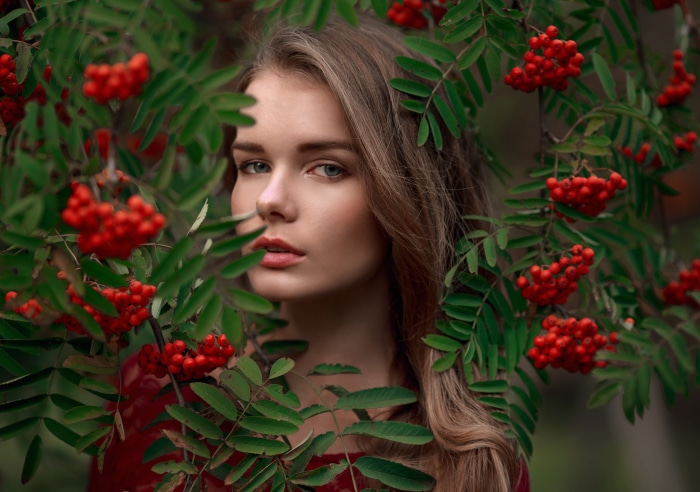 Woman with blonde hair behind rowan berries