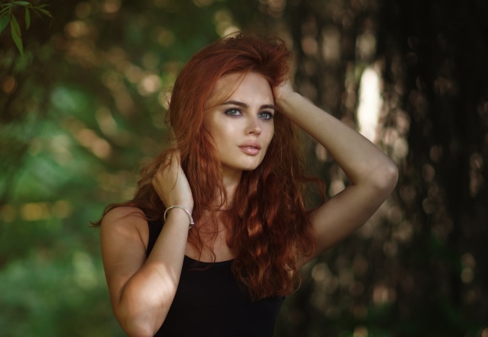 Redhead woman with hands in hair