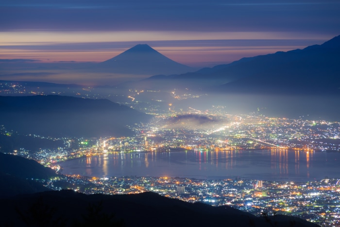 Mount Fuji and city lights at night in Japan