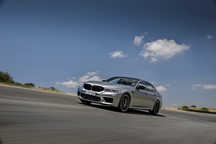 Silver BMW M5 Competition on a Racetrack