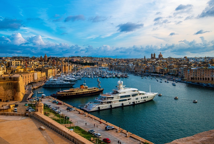 Harbor in Malta with yachts and cityscape