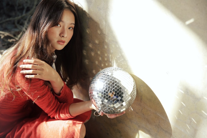 Asian woman with disco ball