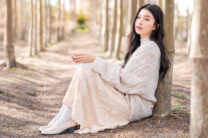 Asian woman with black hair in a forest
