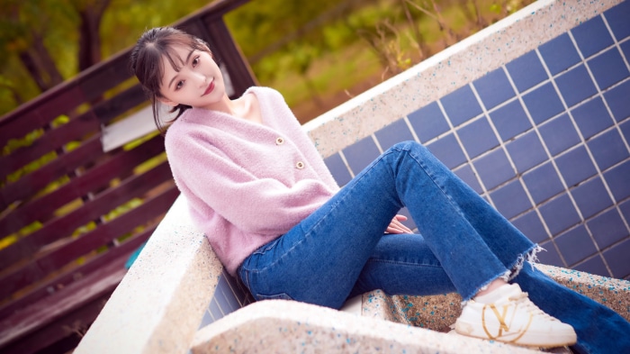Asian Woman in Pink Cardigan and Jeans Outdoors 4K