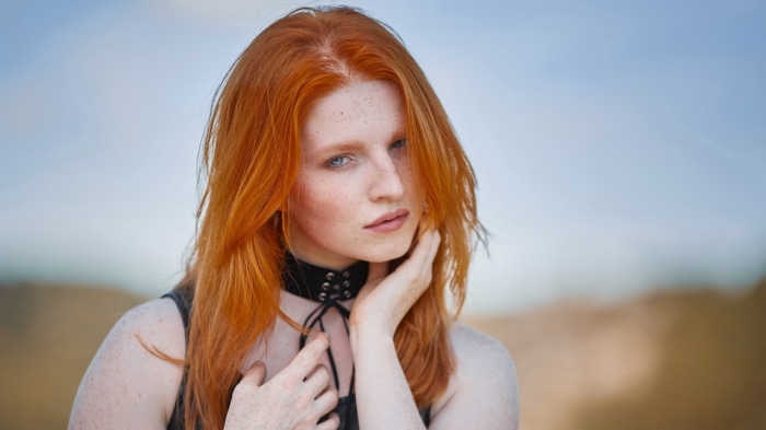 Redhead woman with freckles wearing a choker