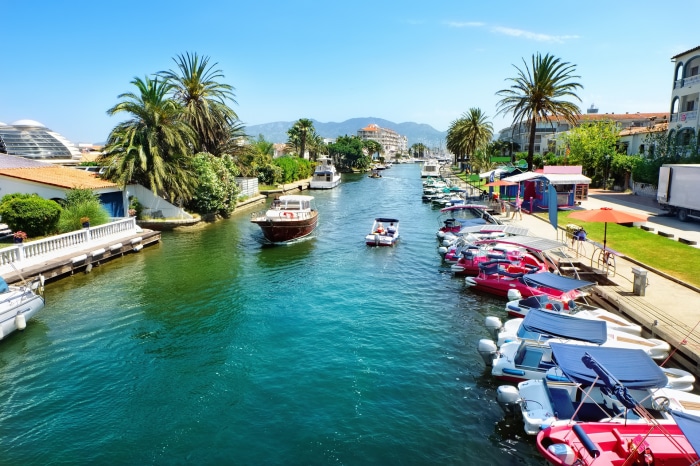 Boats docked on a canal in a Spanish town