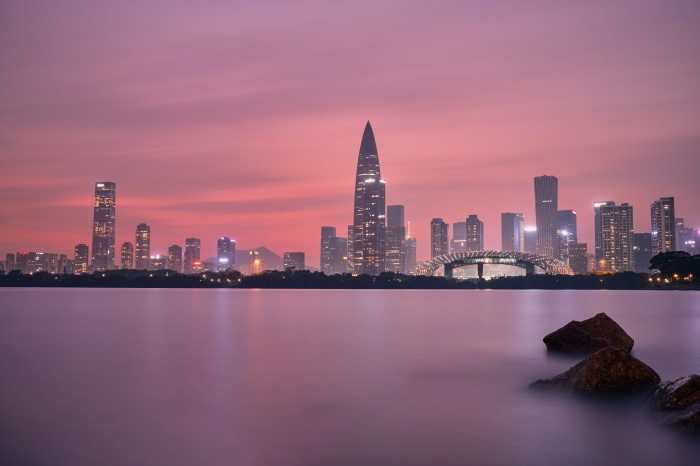 Shenzhen skyline at sunset with water in foreground
