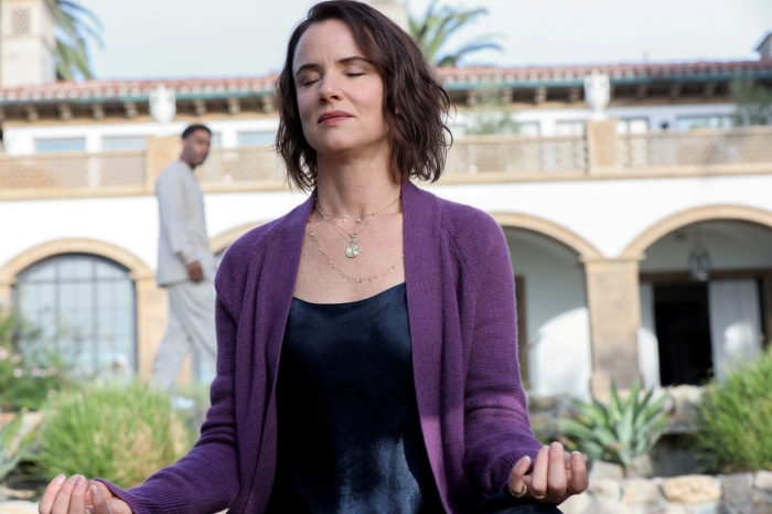 Woman meditating in front of a building