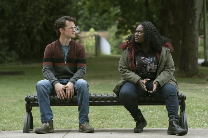 Danielle Brooks and Freddie Stroma sitting on a bench