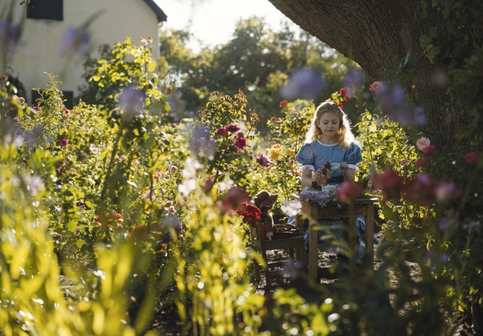 Girl having a tea party in a garden