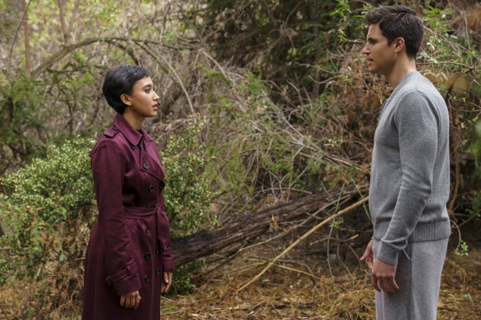 Andy Allo and Robbie Amell in a forest