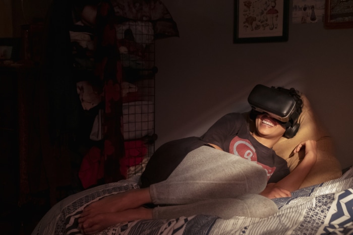 Andy Allo wearing VR headset in bed