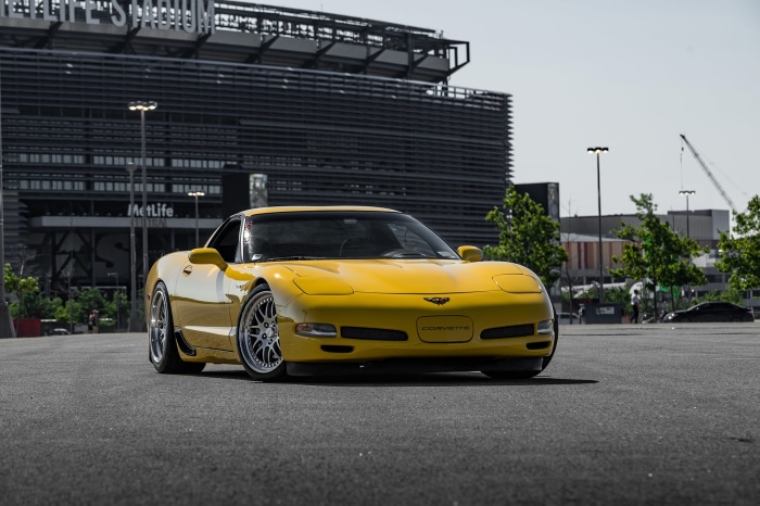 Yellow Chevrolet Corvette Z06 in front of MetLife Stadium