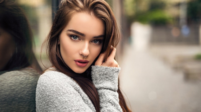 Woman with nose ring and grey sweater