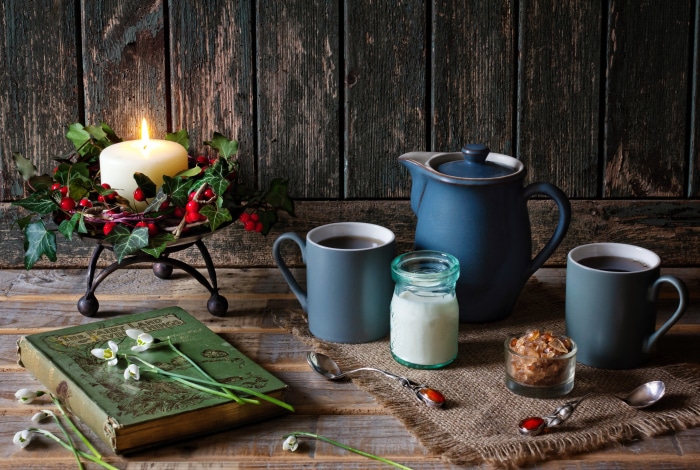 Still life with candle, cups, and book