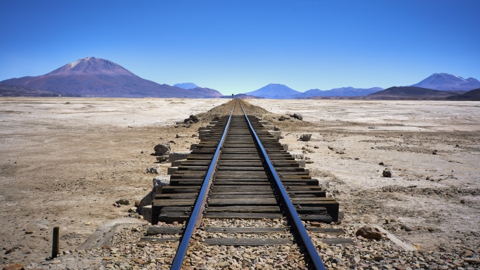 Railroad in a desert landscape with mountains
