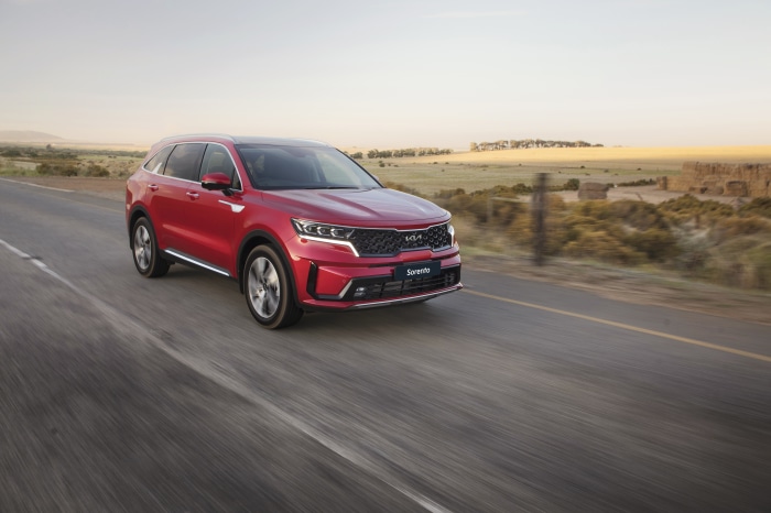 Red Kia Sorento CRDi AWD SUV driving on road