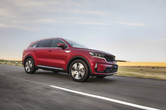 Red Kia Sorento CRDi AWD SUV driving on road