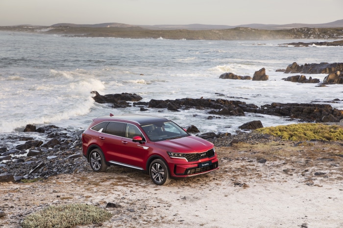 Red Kia Sorento CRDi AWD SUV on rocky coast