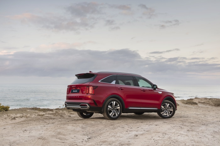 Red Kia Sorento SUV parked by the ocean