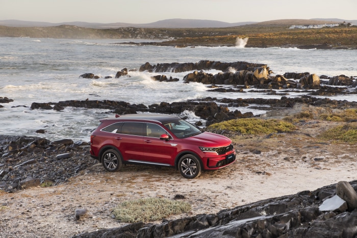 Red Kia Sorento CRDi AWD SUV on rocky coast