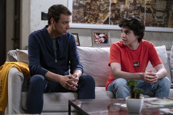 Daniel LaRusso and a young man sitting on a couch