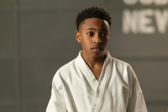 Young boy in a karate gi from Cobra Kai