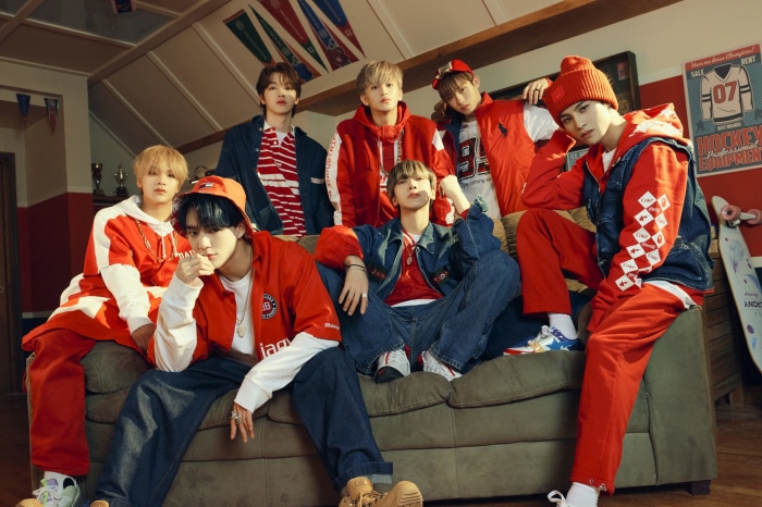 NCT members in red and blue sporty outfits