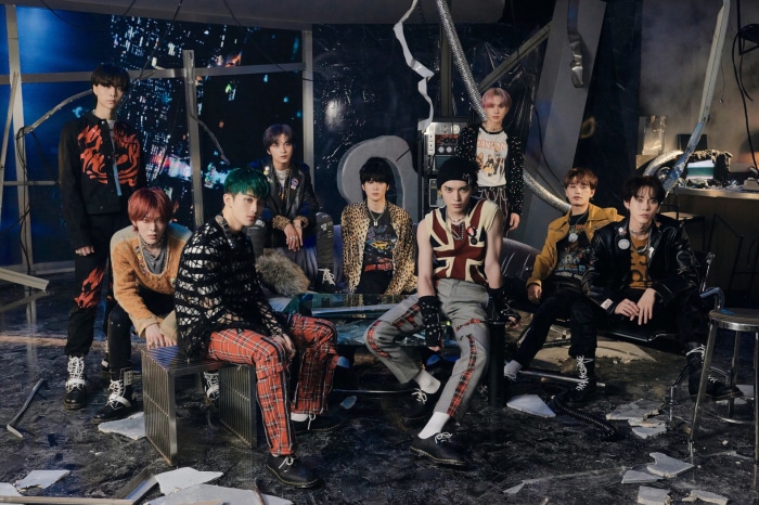 NCT members posing in a grunge-inspired setting