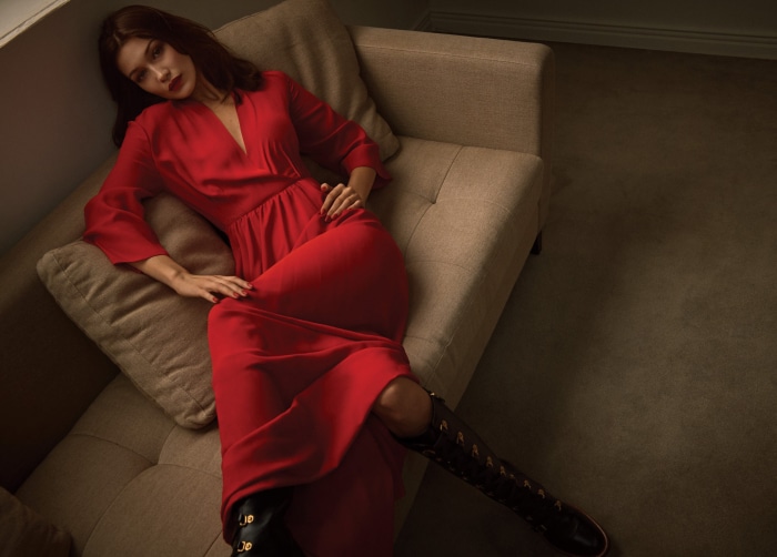 Bella Hadid in red dress on couch