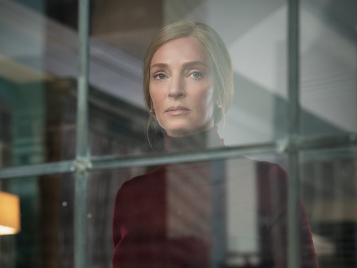 Uma Thurman looking through a window