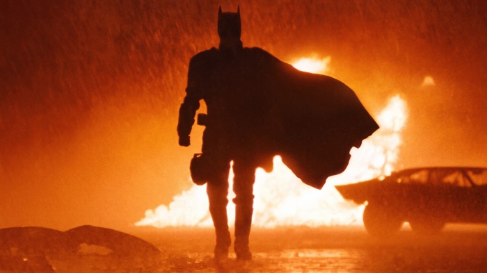 Batman in front of a fire