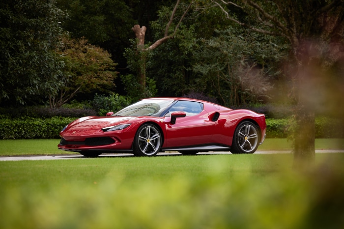 Red Ferrari 296 GTB Supercar on Grass