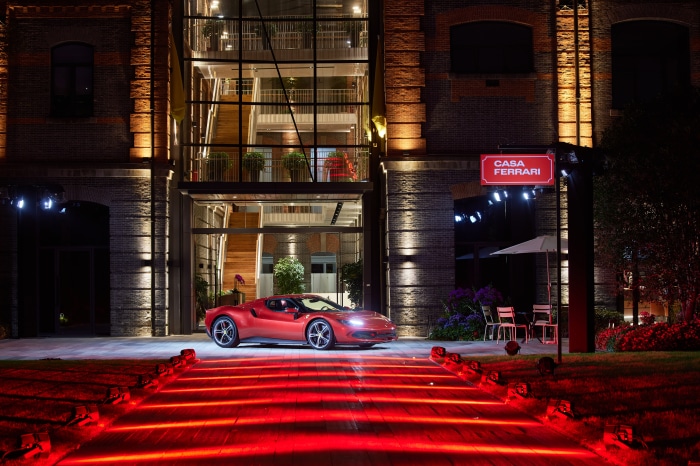 Red Ferrari 296 GTB on a red carpet