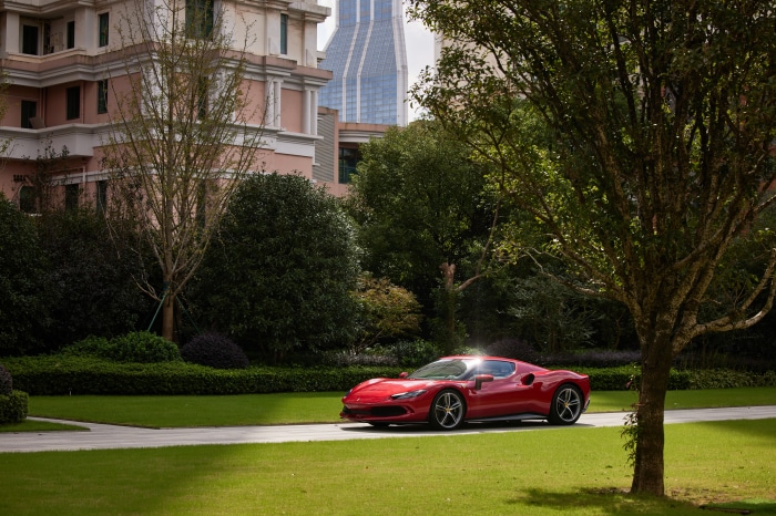 Red Ferrari 296 GTB Supercar on a Road