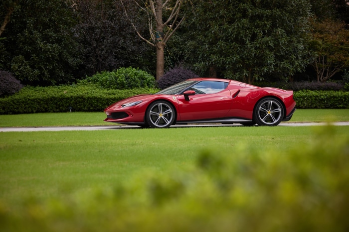 Red Ferrari 296 GTB Supercar on Grass