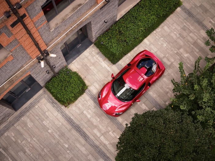 Red Ferrari 296 GTB Supercar parked near building