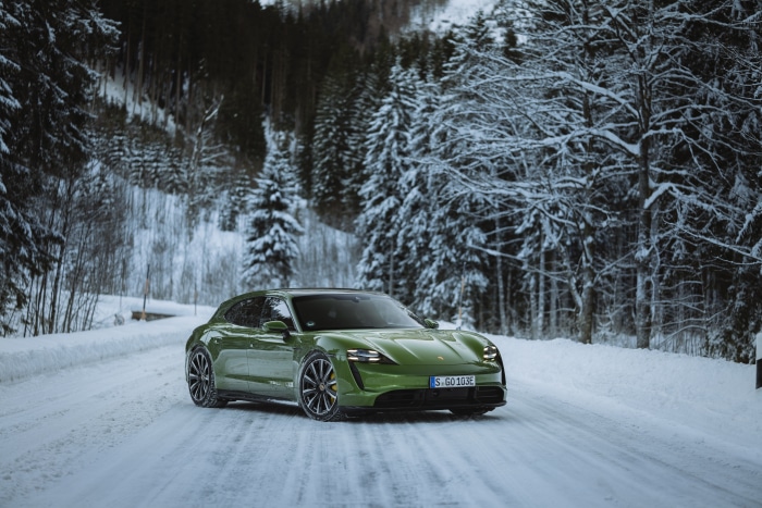 Green Porsche Taycan Turbo S on a Snowy Road