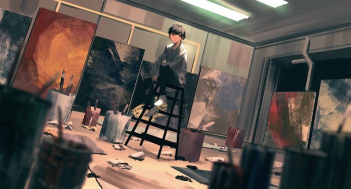Boy in an art studio surrounded by paintings