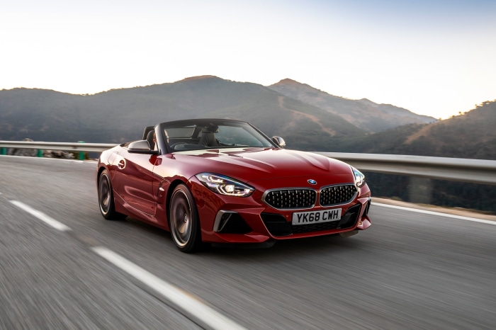 Red BMW Z4 Cabriolet driving on a mountain road