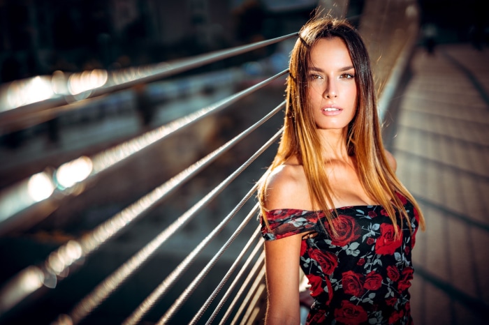 Model in a floral dress on a bridge
