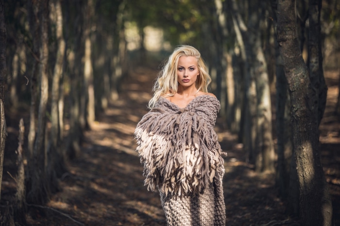 Woman in a knitted shawl in a forest