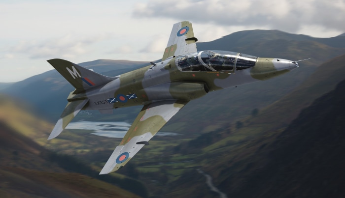 Bae Systems Hawk military jet flying over mountains