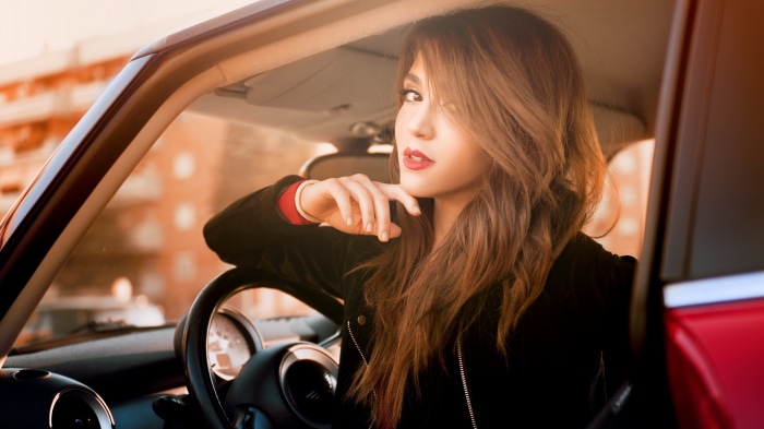 Woman in a red car