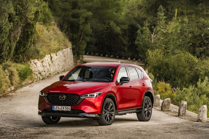 Red Mazda CX-5 SUV on a road