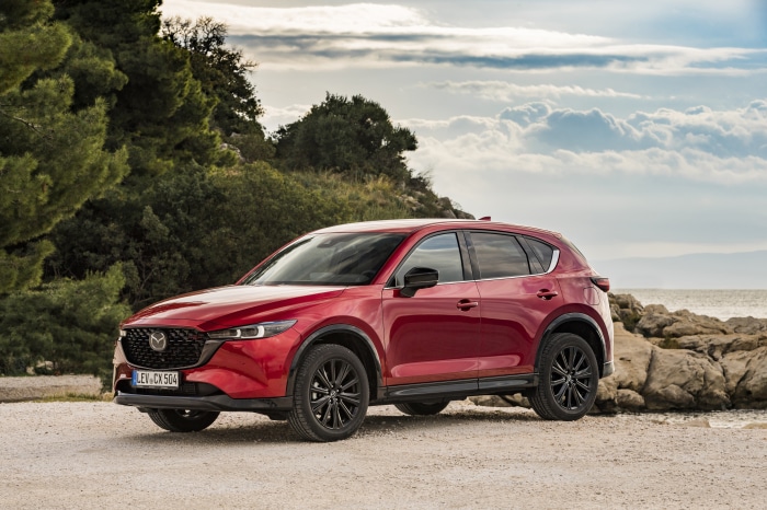 Red Mazda CX-5 SUV parked by the sea
