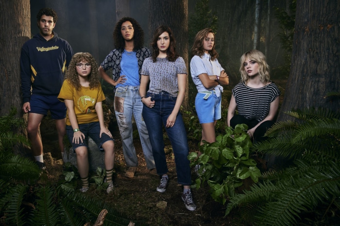 Yellowjackets cast in a forest